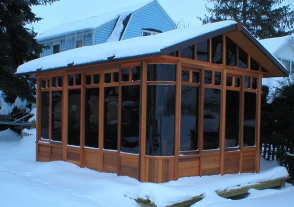 a chalet gazebo with snow on the roof