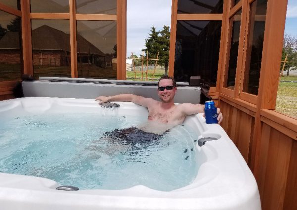 man on hot tub inside gazebo