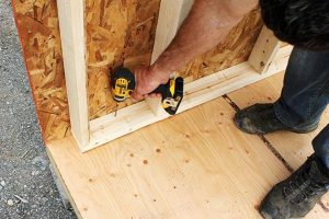 4. Secure back wall to the floor platform with screws.